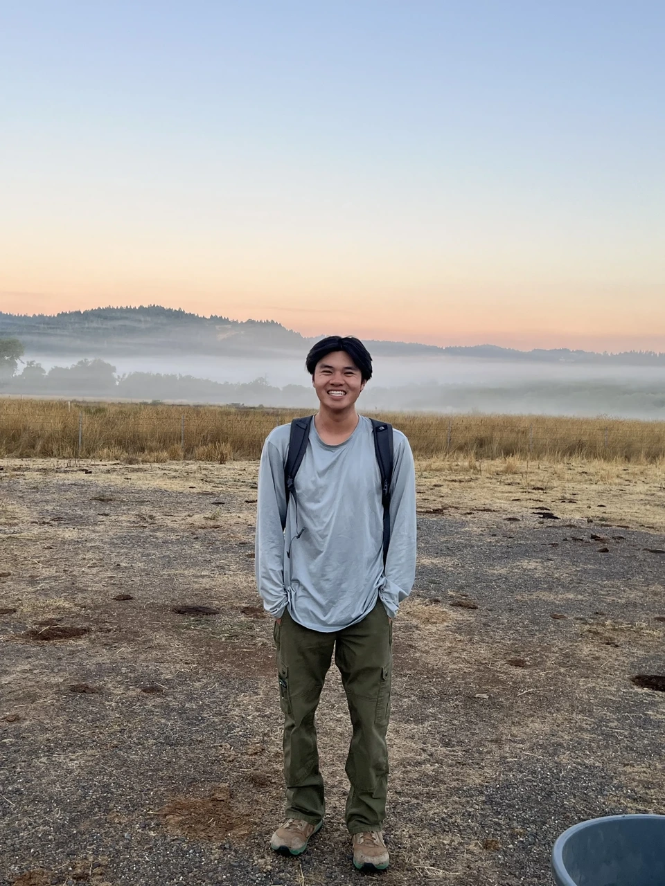 Kyle standing in a misty California field at sunrise